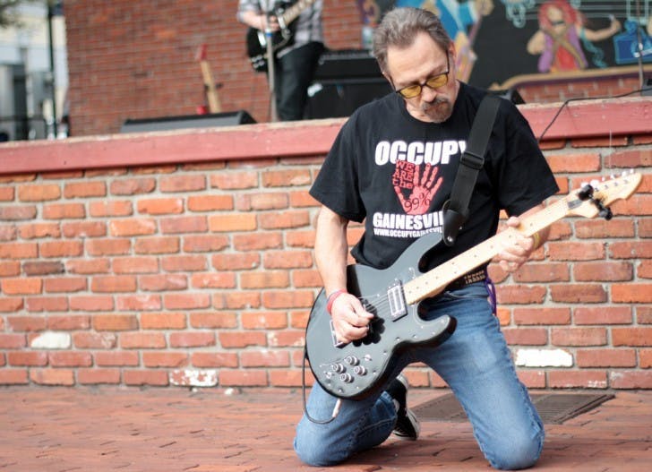 Brian Krashpad, frontman of the local punk rock band Crash Pad, plays downtown at the Fight Back Florida Gainesville Rocks the Vote rally Saturday afternoon.