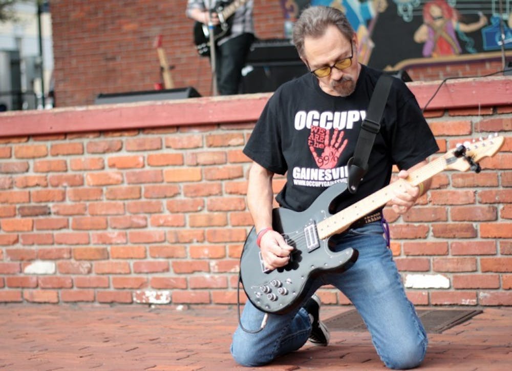 <p>Brian Krashpad, frontman of the local punk rock band Crash Pad, plays downtown at the Fight Back Florida Gainesville Rocks the Vote rally Saturday afternoon.</p>