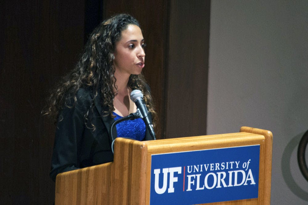 Joselin Padron-Rasines, a political science and international studies junior, presents the Access Party opening statement for the University of Florida Student Government Executive Debate on Tuesday in the University Auditorium. Padron-Rasines is running as presidential candidate.