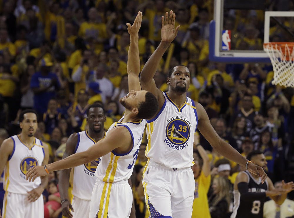 <p>Warriors forward Kevin Durant (35) and guard Stephen Curry celebrate during Game 1 of the Western Conference Finals on May 14, 2017, at Oracle Arena.</p>