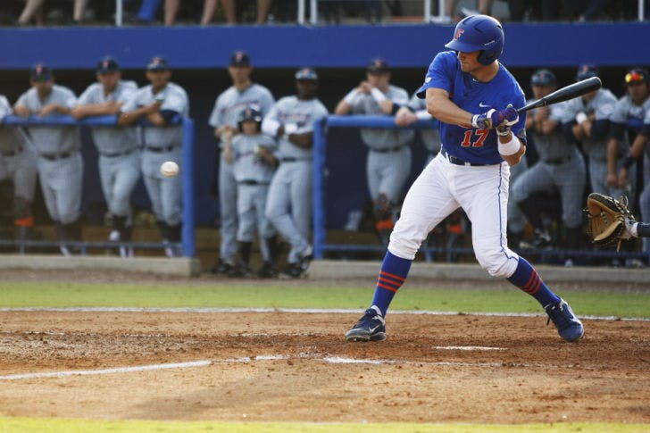 Sophomore catcher Taylor Gushue swings during Florida’s 7-3 victory against Cal State Fullerton on Feb. 17, 2012 at McKethan Stadium. Gushue &nbsp;went 2 for 3 at the plate on Saturday. His two-run single in the eighth inning helped Florida even its series against Miami.

