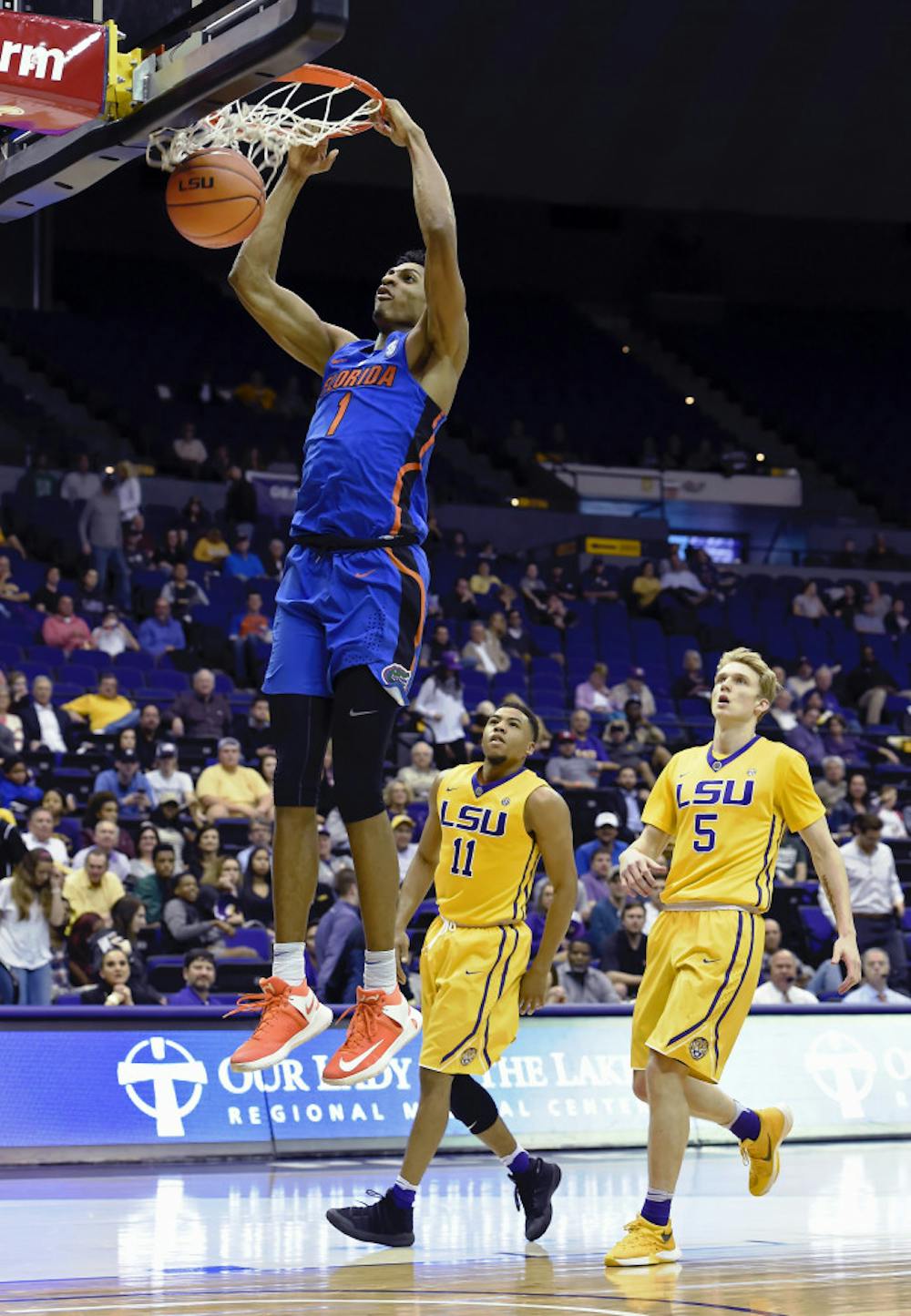 <p>Florida forward Devin Robinson (1) dunks the ball for two of his game high 24-points as LSU guard Jalyn Patterson (11) and LSU guard Kieran Hayward (5) watch in the second half of an NCAA college basketball game, Wednesday, Jan. 25, 2017, in Baton Rouge, La. Florida won 106-71. (AP Photo/Bill Feig)</p>