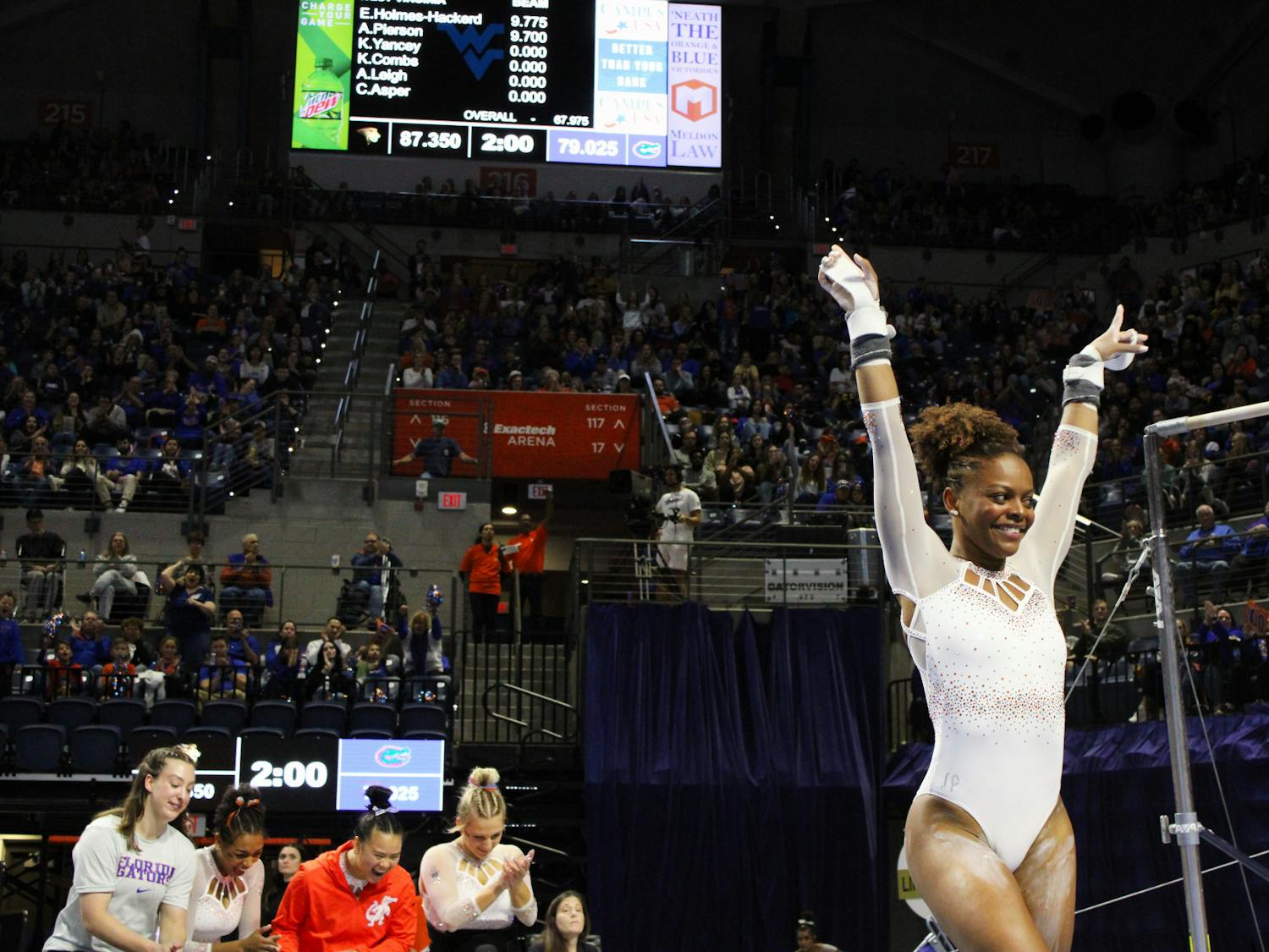 Florida graduate student Trinity Thomas dismounts the bars at the end of her routine in a quad meet against the West Virginia Mountaineers, Ball State Cardinals and the Lindenwood Lions Friday, Jan. 6, 2023. 