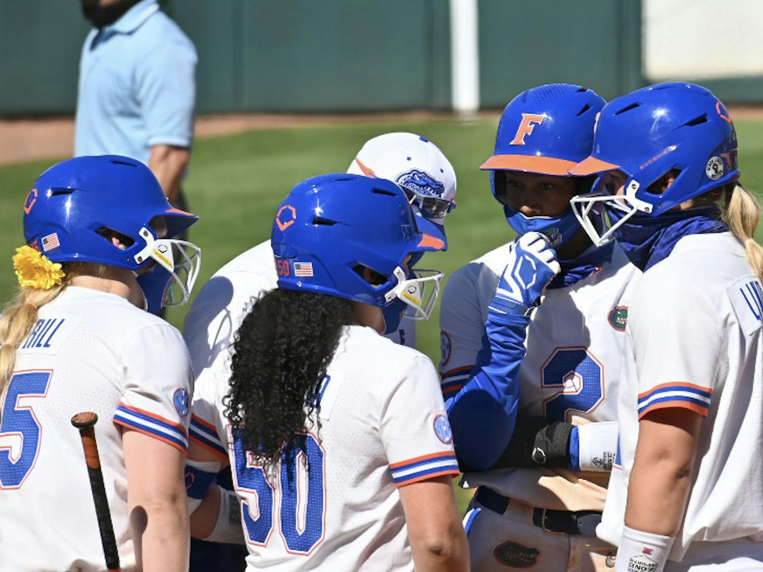 Florida softball huddles in a Feb. 20 matchup against Charlotte.