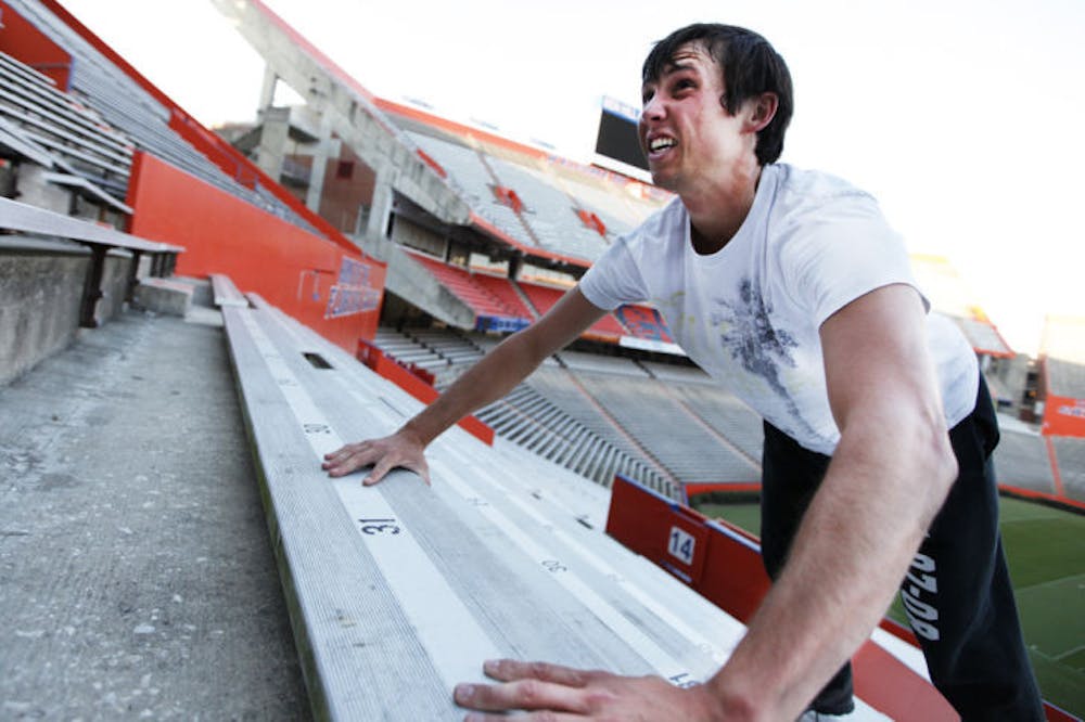 <p>Conrad Cahoon, 22, a UF alumnus and intern with the Florida Springs Institute, exercises at Ben Hill Griffin Stadium on Tuesday evening.</p>