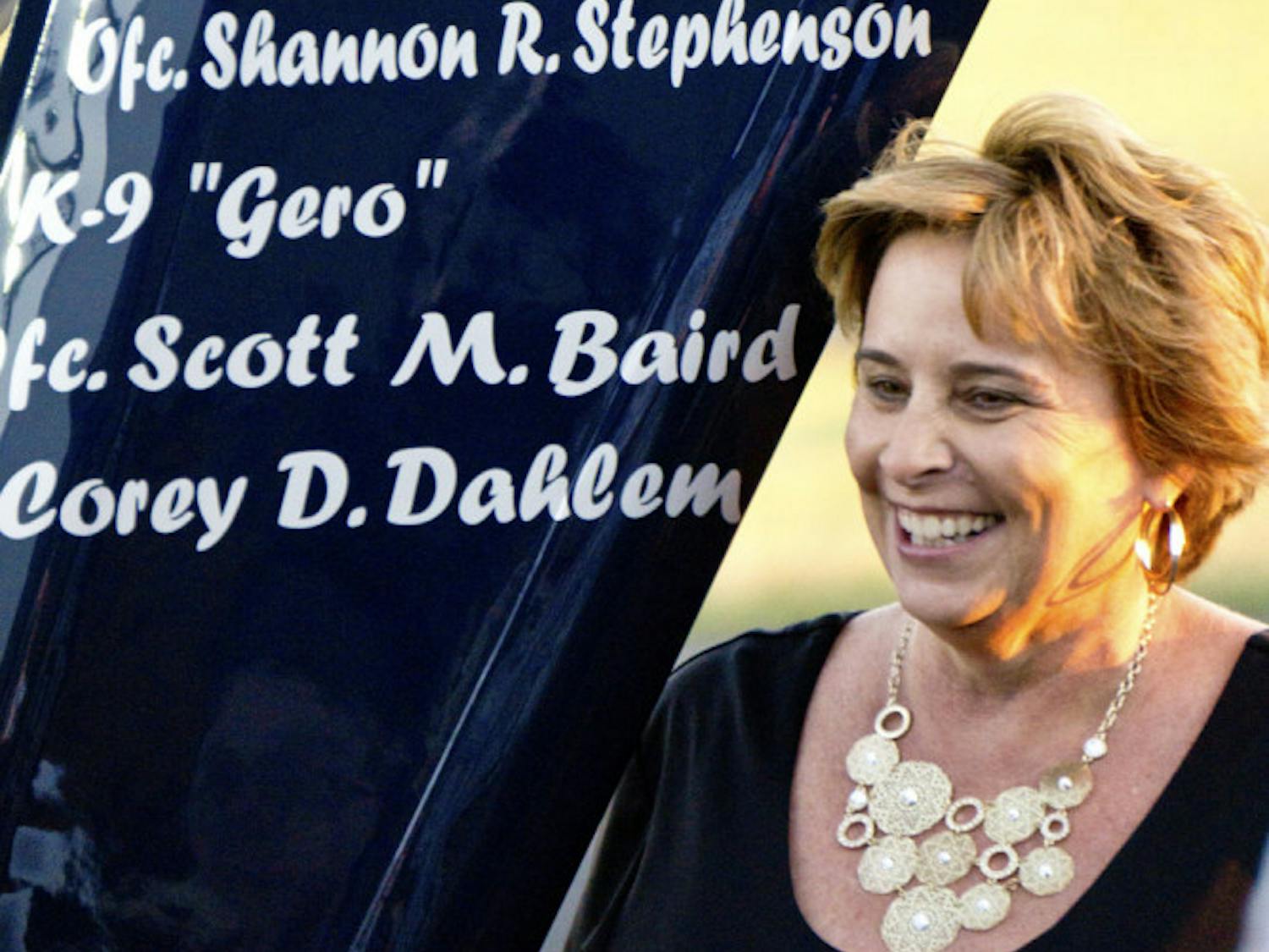 Sally Dahlem, widow of Lt. Corey Dahlem, stands next to a helicopter that was repainted to memorialize her husband and other fallen police officers. “I think it’s beautiful,” she said. “It was a wonderful surprise.”