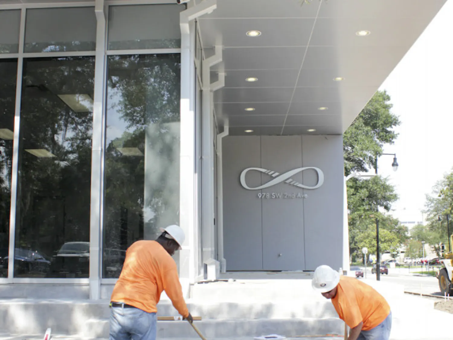 O'Steen Brothers employees Eddie Wesley and John Ludwig work outside Infinity Hall on July 29, 2015.