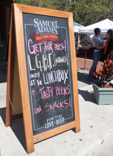 A sign advertising a Pride-friendly specialty sandwich sits in front of The Lunchbox, a cafe in downtown Gainesville.