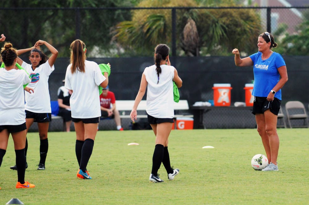 <p>UF soccer coach Becky Burleigh leads practice prior to Florida's 2-1 win against Troy in an exhibition match on Aug. 11, 2015, at the soccer practice field at Donald R. Dizney Stadium.</p>