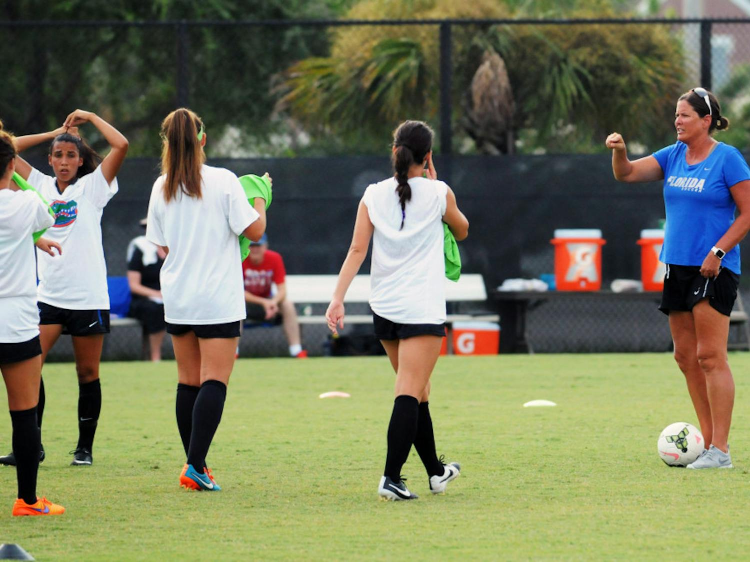 UF soccer coach Becky Burleigh leads practice prior to Florida's 2-1 win against Troy in an exhibition match on Aug. 11, 2015, at the soccer practice field at Donald R. Dizney Stadium.