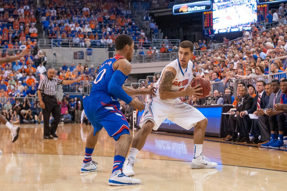 <p>Scottie Wilbekin faces off against Kansas point guard Frank Mason (0)during the Gators' 67-61 win against the Jayhawks Dec. 10, 2013 in the O'Connell Center.</p>