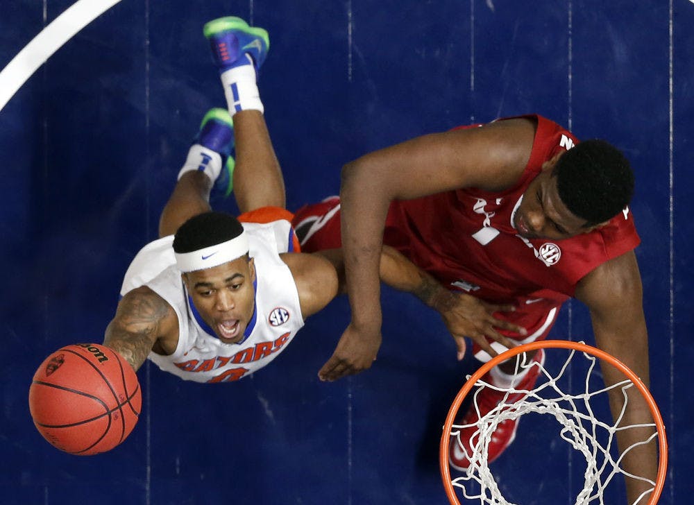 <p>Florida's Kasey Hill, left, drives to the basket against Arkansas's Trey Thompson, right, during the first half of an NCAA college basketball game in the Southeastern Conference tournament in Nashville, Tenn., Thursday, March 10, 2016. (AP Photo/John Bazemore)Florida won 68-61.</p>