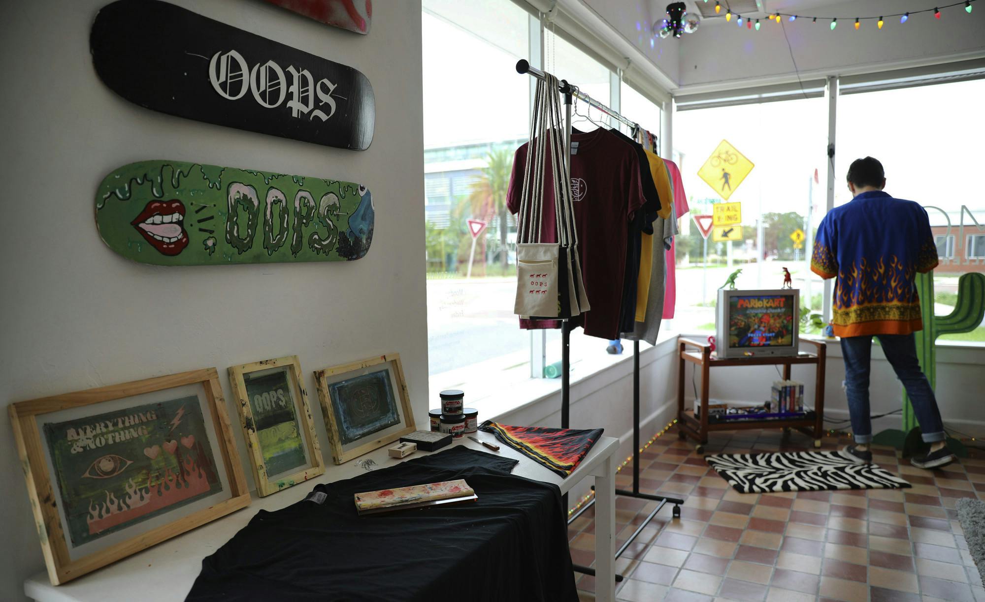 Dennis Pfeiffer, 22, adjusts the position of items in the Out Of Pocket Society pop-up event at 4Most Gallery on Friday, June 18, 2021. 