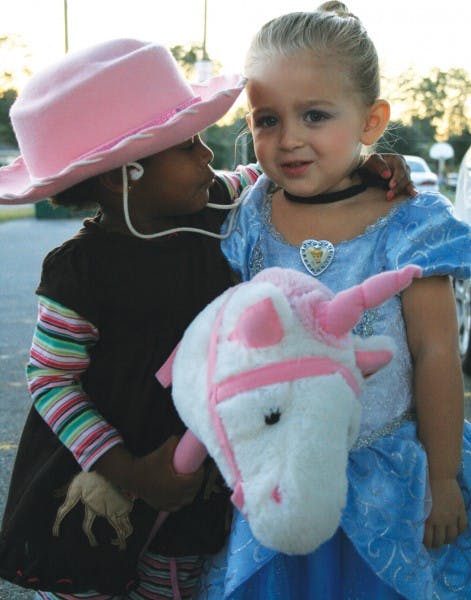 Two-year-old Farrah, right, and Davis spend Halloween together with Williams, Davis’ adopted father, and his mother. Farrah and Davis are cousins, but Williams said they are growing up like sisters.