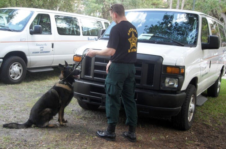 A German Shepherd police dog, Apollo, is led by Marion County Sheriff's Office Deputy Greg Combs. Apollo sniffs out narcotics for his yearly certification requirements.