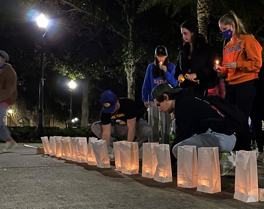 <p>UF students and community members gathered at Plaza of the Americas for a commemorative candlelight vigil to honor the victims of the Parkland shooting on Monday, Feb. 14. </p>