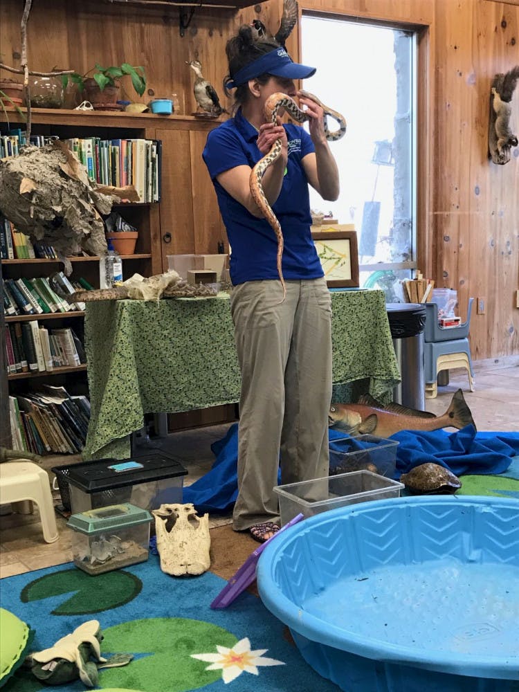 Sally Wazny shows kids the checkerboard pattern of a red rat snake belly.