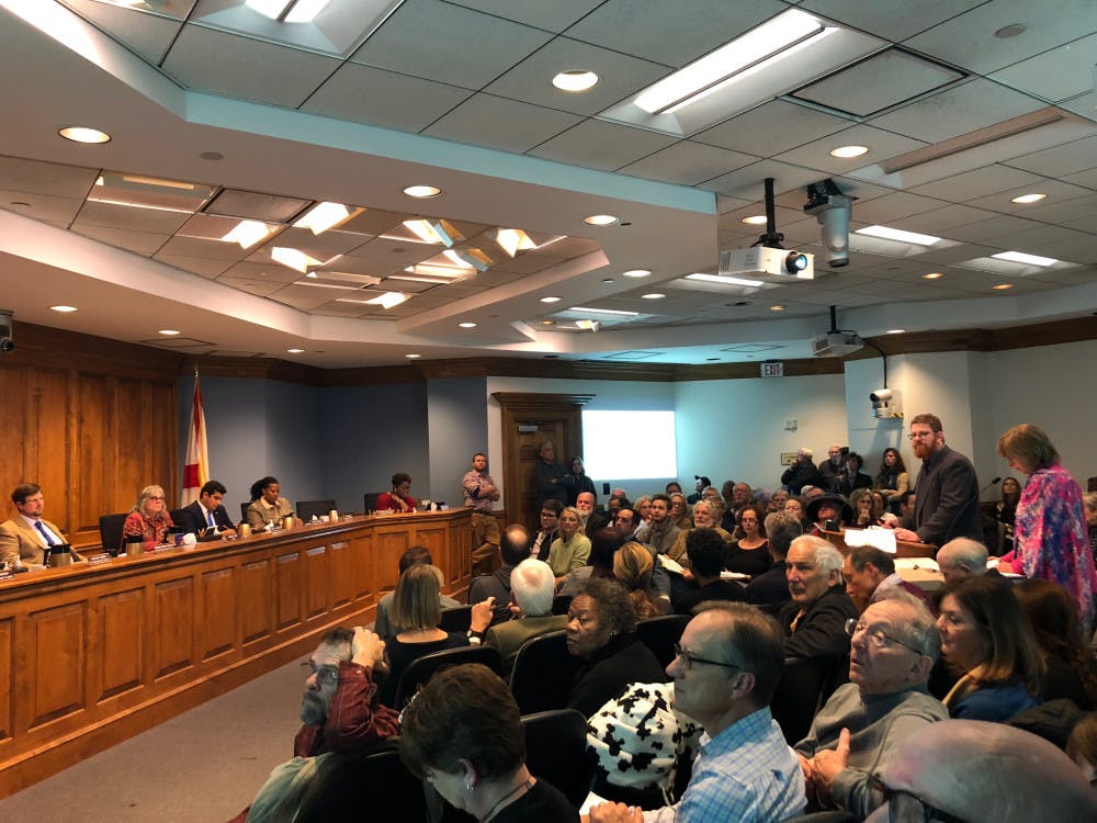 [FILE PHOTO] Andrew Persons, a Gainesville city planner, and Wendy Thomas, the city’s director of the department of doing, present information on gnvRISE affordable housing program at the beginning of a six-hour meeting. 