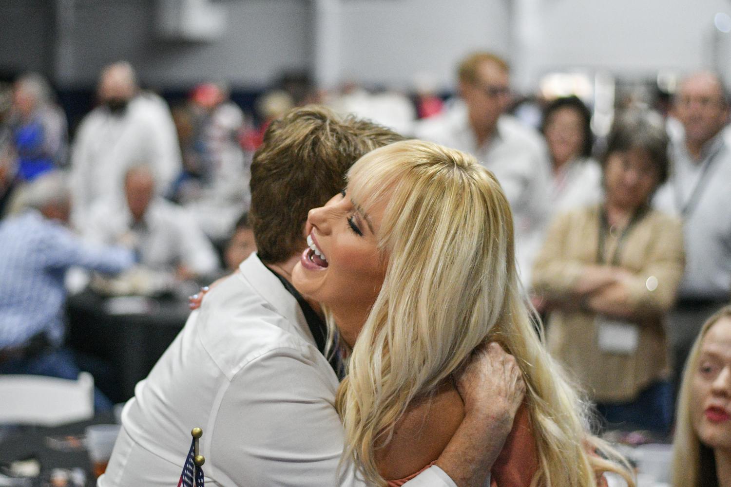 Tomi Lahren, a contributor for Fox News, hugs Ellen Ault, a member of the Alachua County Republican Party, Thursday night at the 16th Annual Ronald Reagan Black Tie and Blue Jeans Barbecue. Lahren was the keynote speaker at the sold-out event put on by the Alachua County Republican Party in Legacy Park.