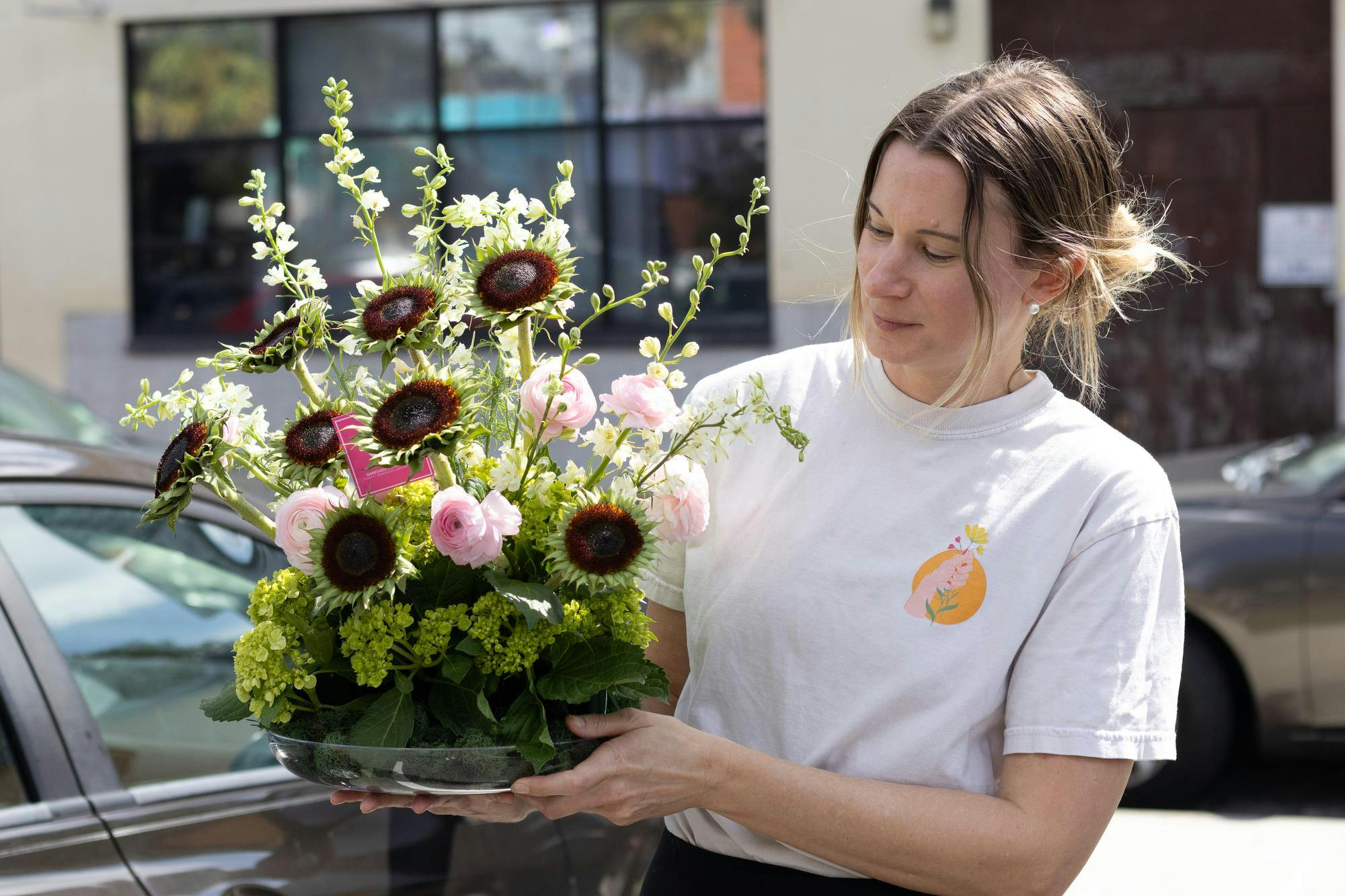 Sunny and Share flower service owner Nicole Germany delivers an arrangement for an opening day celebration at a shop in downtown Gainesville, Fla., Friday, Sept. 18, 2026.