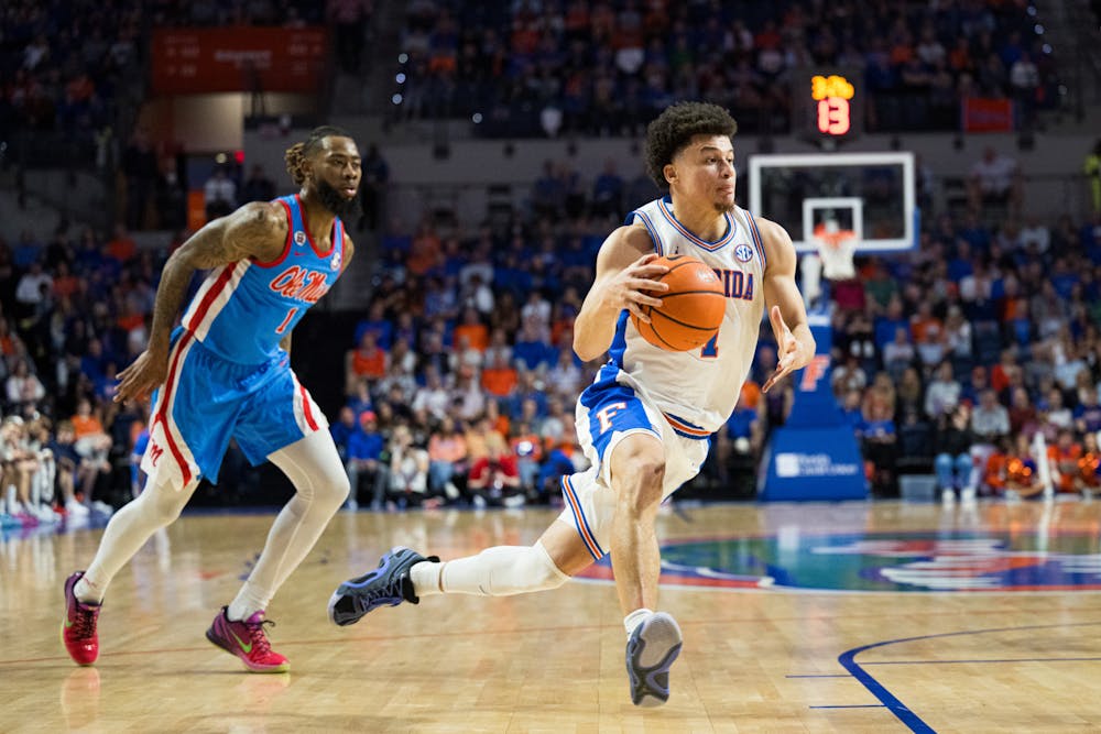 Florida Gators guard Walter Clayton Jr. (1) drives with the ball in a basketball game against Ole Miss on Saturday, March 8, 2025, in Gainesville, Fla.