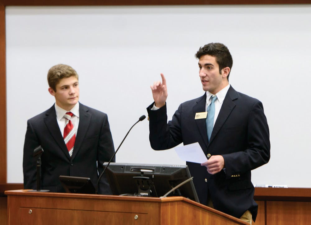 <p>UF Senators Jason Richards, left, and Bronco Vuskovich present Fall and Spring reapportionment at Tuesday night's Senate meeting.</p>