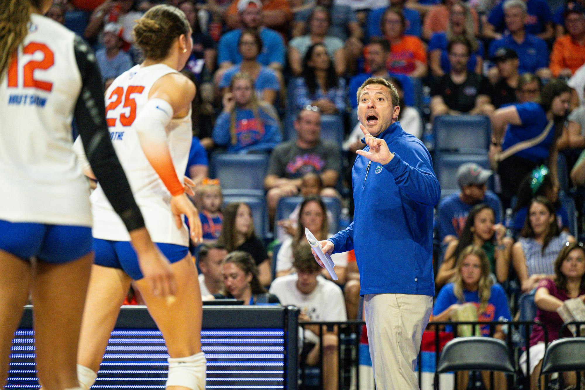 Florida Gators Volleyball head coach Ryan Theis talks to outside hitter Kira Hutson (12) and middle blocker Alec Rothe (25) during a volleyball match against the Norfolk State Spartans on Sunday, Aug. 31, 2025, at the O'Connell Center in Gainesville, Fla.
