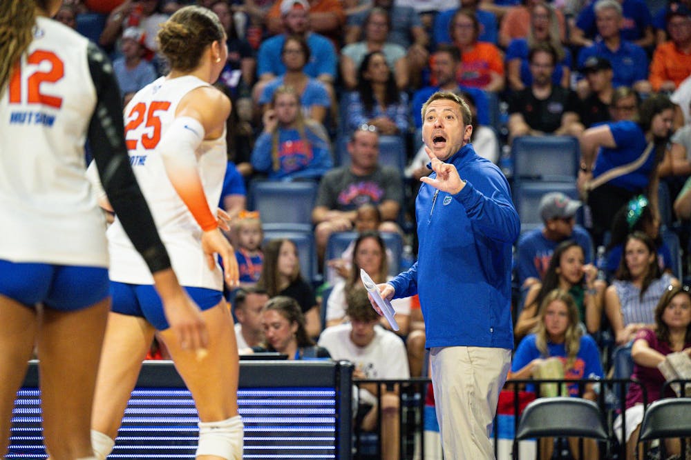 <p>Florida Gators Volleyball head coach Ryan Theis talks to outside hitter Kira Hutson (12) and middle blocker Alec Rothe (25) during a volleyball match against the Norfolk State Spartans on Sunday, Aug. 31, 2025, at the O'Connell Center in Gainesville, Fla.</p>