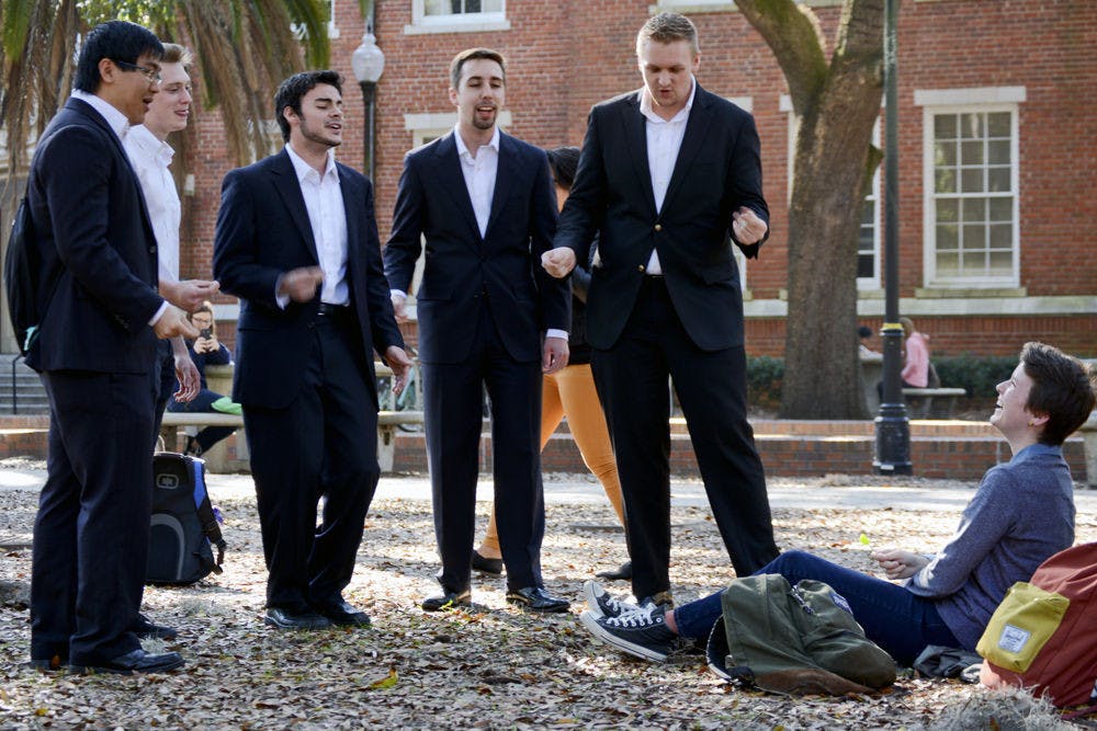 Leah Warwick, a 21-year-old UF sociology senior, laughs while she watches members of Phi Mu Alpha, a music fraternity, perform a song for her. “I wasn’t expecting it,” Warwick said. “It’s cheesy in a good way.”