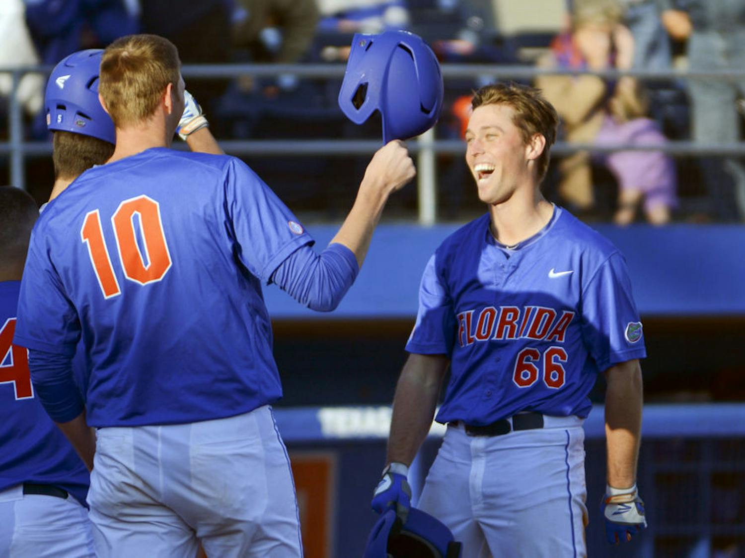Ryan Larson celebrates with A.J. Puk (10) after hitting a home run during Florida's 22-3 win against Rhode Island on Saturday at McKethan Stadium.