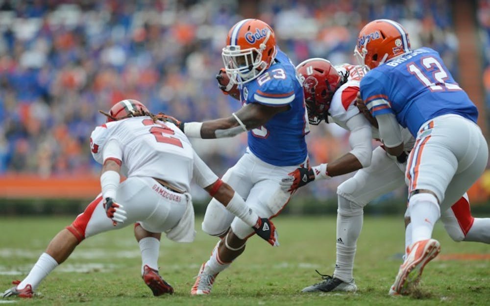 <p>Running back Mike Gillislee (23) attempts to run through the Jacksonville State defense as quarterback Jacoby Brissett (12) blocks during UF’s 23-0 win on Saturday in The Swamp.</p>
<div><span><br /></span></div>
