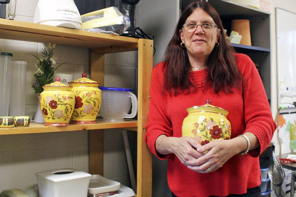 Louise Yariv, an ESOL teacher at Gainesville High School, stands in one of her prop donation closets. Yariv gives donations to the families of her ESOL students and those in need.