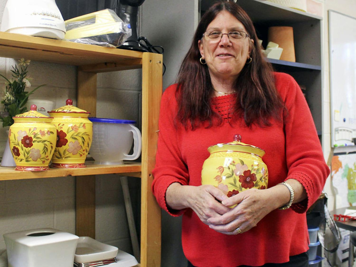 Louise Yariv, an ESOL teacher at Gainesville High School, stands in one of her prop donation closets. Yariv gives donations to the families of her ESOL students and those in need.