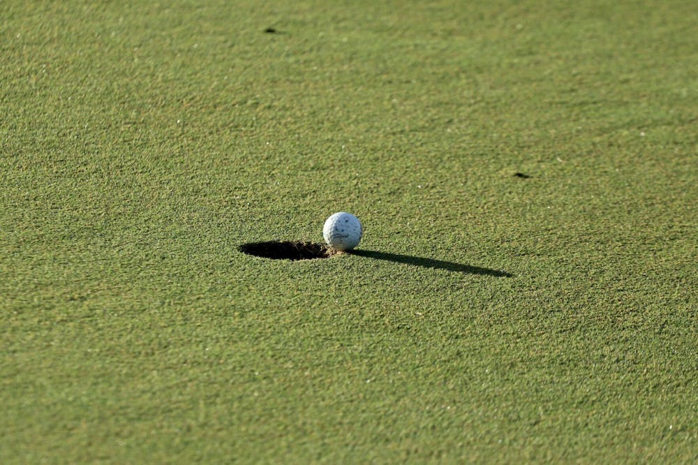 A ball hangs over the hole at Mark Bostick Golf Course