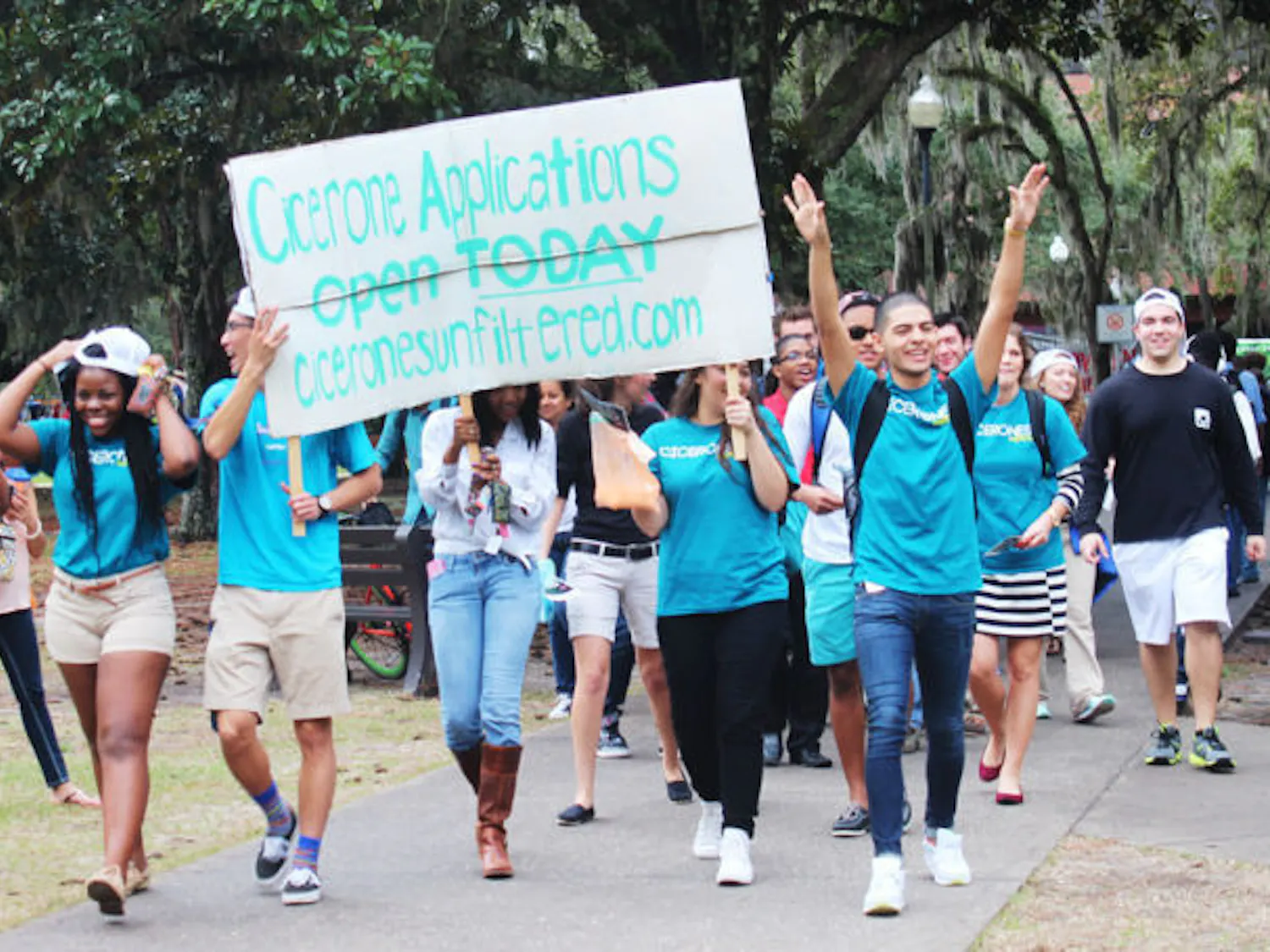 Members of the Florida Cicerones march in a parade to promote the opening of applications and the organization's Spring Forum on Jan. 14. The parade began in front of the HUB and ended on the Plaza of the Americas where representatives of the Gator Run threw orange and blue powder on the parade participants.