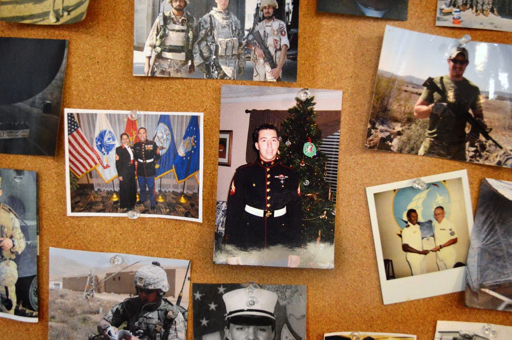 Photographs of members in uniform and in the field are displayed on the walls of the Collegiate Veterans Success Center.
