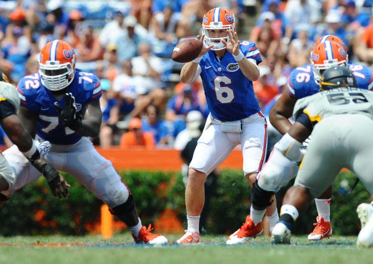 Jeff Driskel reaches for a snapped ball during Florida’s 24-6 victory against Toledo on Saturday in Ben Hill Griffin Stadium. Driskel completed 17 of 22 passes for 153 yards and a touchdown in the game.