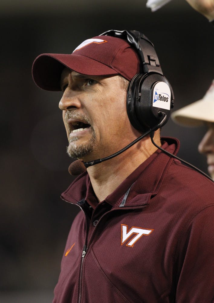 FILE - In this Oct. 15, 2011, file photo, Virginia Tech defensive coordinator Bud Foster against Wake Forest during the second half of an NCAA college football game in Winston-Salem, N.C. Foster found out quickly that just because his players have extra cash in the form of stipends, it does not mean he can fine them when they screw up. Coaches cannot take away scholarship money, but they can withhold things like tickets, bowl gifts and per diems. (AP Photo/Bob Leverone, File)