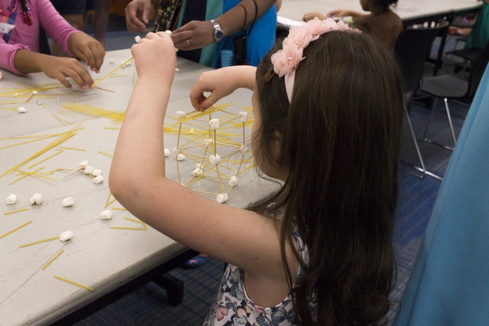 <p><span id="docs-internal-guid-041537fd-b80e-5b00-5914-eb6162f76b1f"><span>A Girl Scout uses dry spaghetti and mini marshmallows to create different structures.</span></span></p>