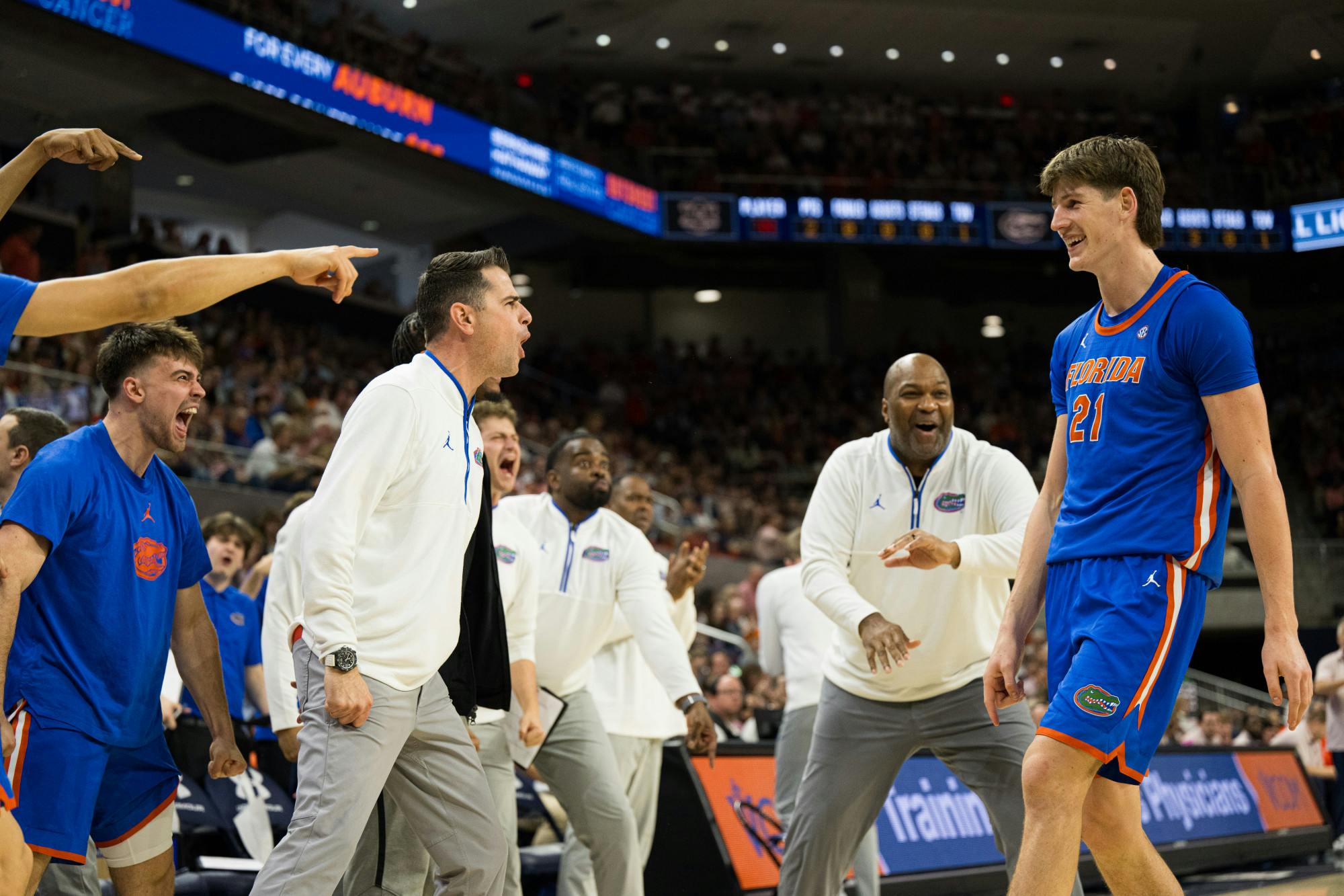 Florida Gators Head Coach Todd Golden embraces forward/center Alex Condon (21) after making a basket in a basketball game against Auburn University on Feb. 8, 2025, in Auburn, Ala.