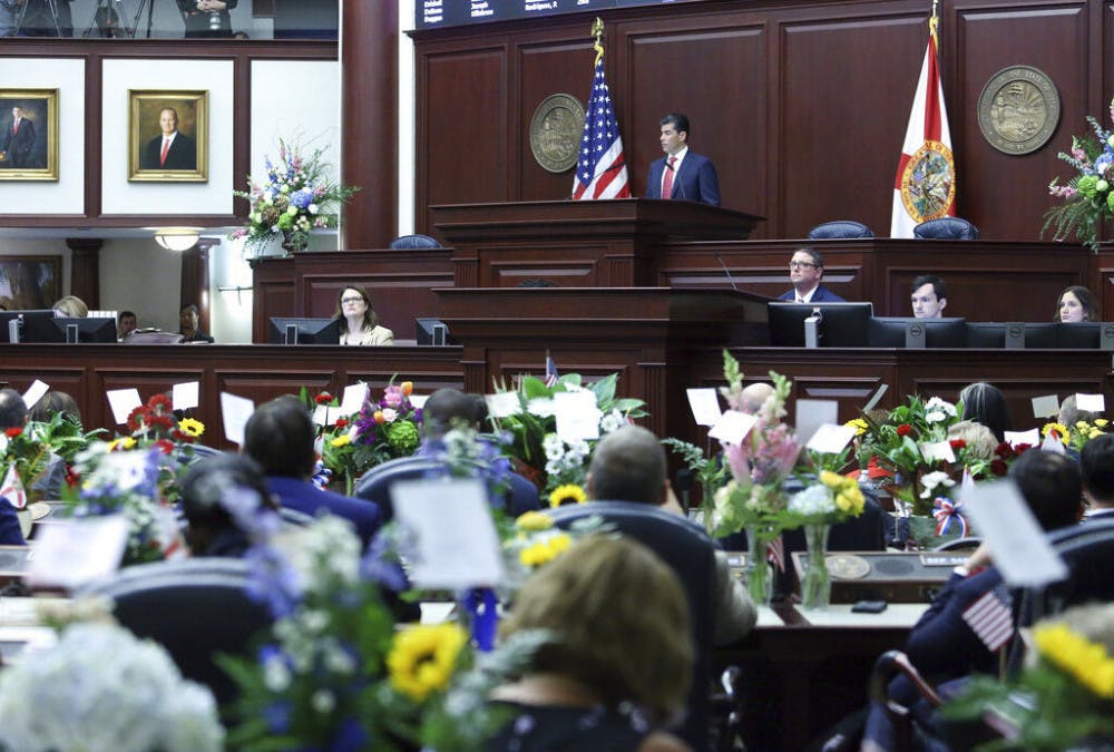 Florida House Speaker Jose Oliva, R-Miami Lakes, center, addresses the House at the start of session on Tuesday Jan. 14, 2020, in Tallahassee, Fla. (AP Photo/Steve Cannon)