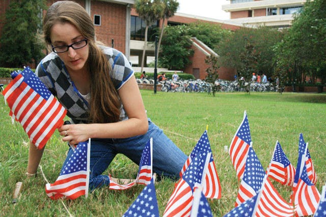 Graduate student Jean Morrow places exactly 2,977 miniature flags on the lawn of the Reitz Union lawn to honor each person who died on 9/11, marking the 10th anniversary of the national tragedy. Morrow's display is part of the 9/11: Never Forget Project at UF.
