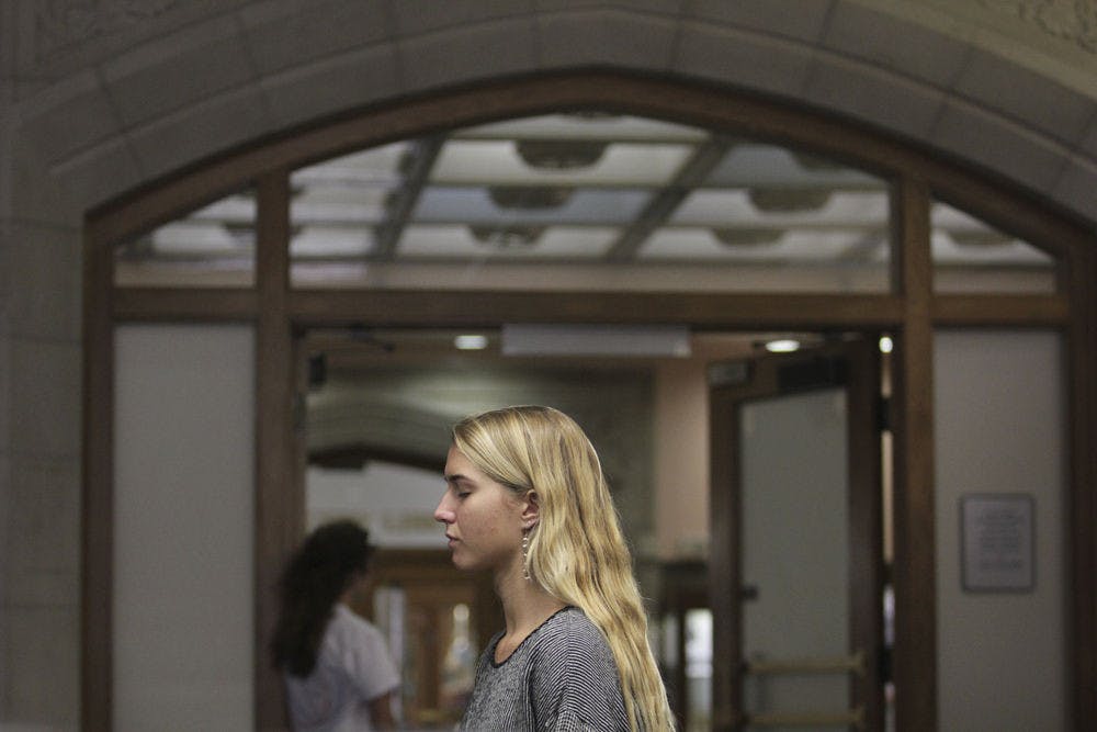 Lauren Schinnow, an 18-year-old Santa Fe engineering freshman, meditates in Smathers Library before MedMob. “I think the energy level will be higher with so many people doing it together at the same time,” said Schinnow, who said she’d meditated before by herself.