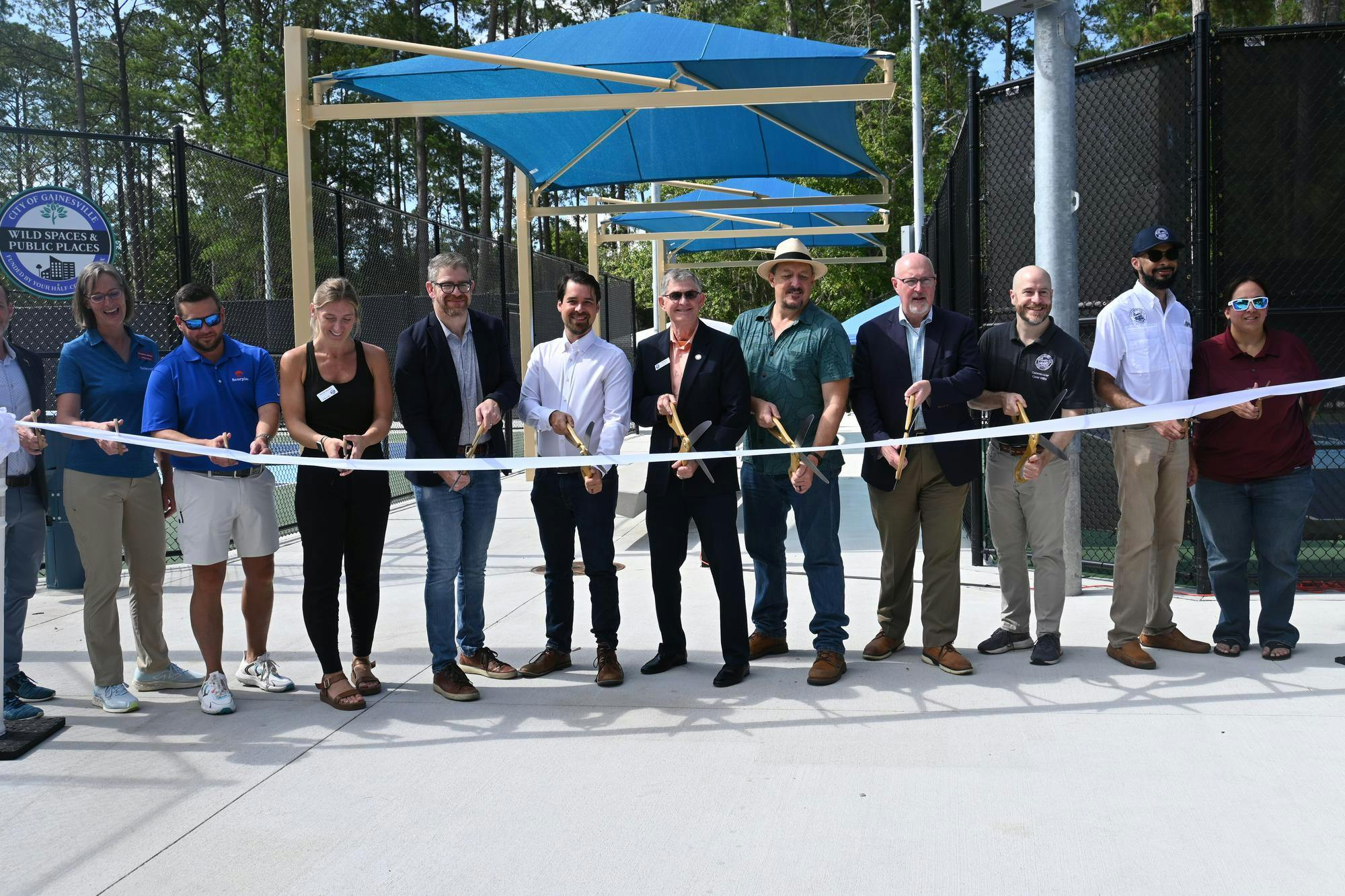 Gainesville Mayor Harvey Ward and other city leaders cut a ribbon commemorating the opening of new pickleball courts and park renovations, Saturday, June 6, 2026, at Tom Petty Park in Gainesville, Fla.