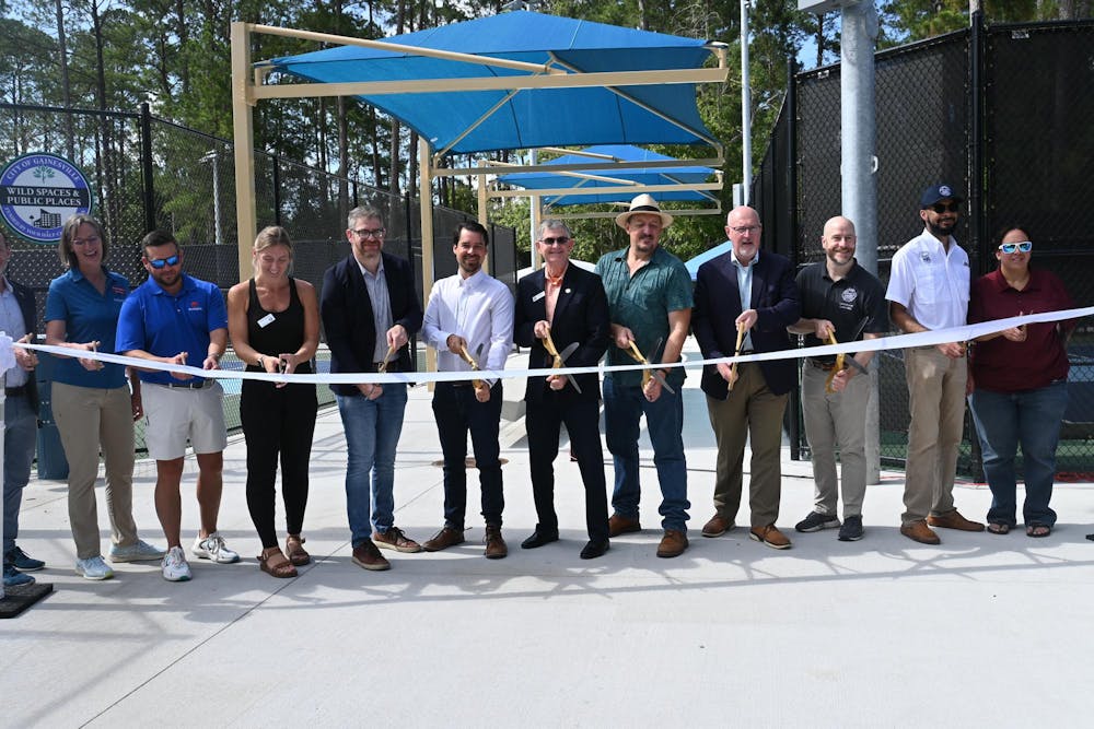 Gainesville Mayor Harvey Ward and other city leaders cut a ribbon commemorating the opening of new pickleball courts and park renovations, Saturday, June 6, 2026, at Tom Petty Park in Gainesville, Fla.