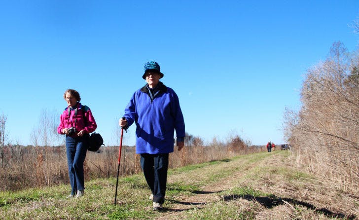 Gainesville resident Mary Horn (right) explores the newly opened Barr Hammock Preserve with Emily Hoon, an Alachua County resident, at the opening celebration Saturday morning. The pair walked along the 6.5-mile Levy Loop hiking trail, which circles around restored marsh.