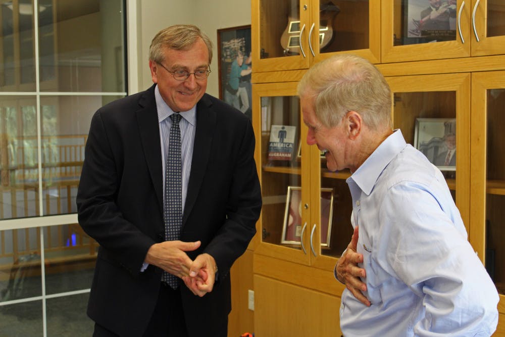Sen. Bill Nelson (D - Florida) laughs as he talks to UF President Kent Fuchs. Fuchs dropped by during Nelson’s discussion with college students about student loan rates at Pugh Hall on Tuesday.