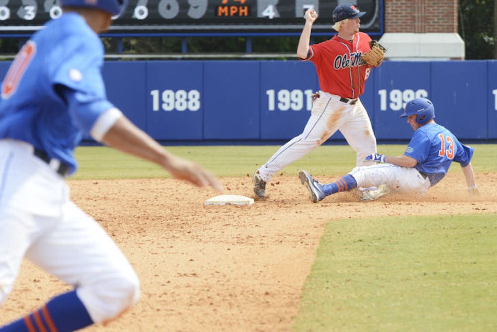 <p class="p1"><span class="s1">Sophomore outfielder Connor Mitchell (13) slides into second base during Florida’s 4-0 win against Ole Miss on March 31 at McKethan Stadium.</span></p>