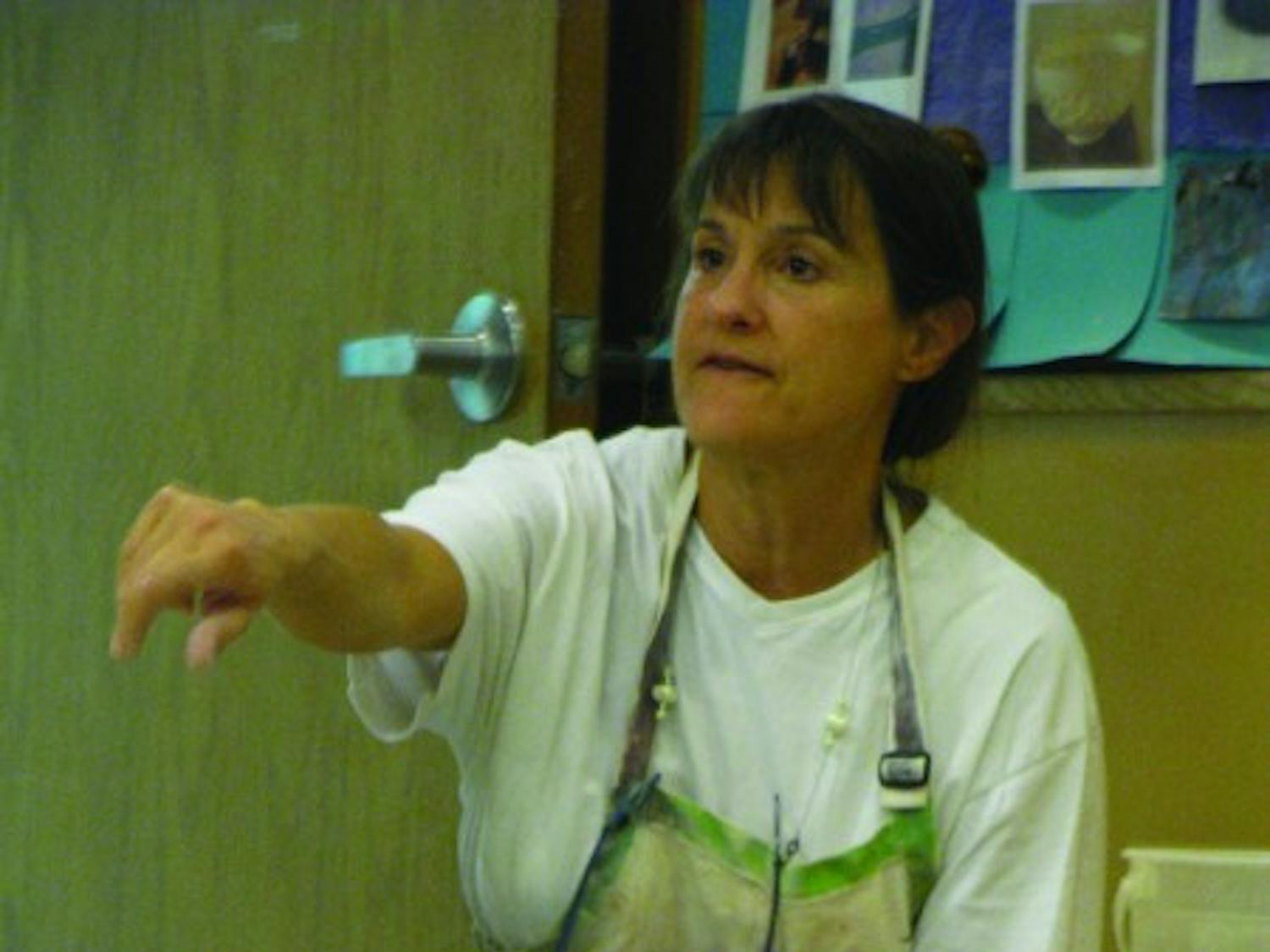 Teresa Davis instructs her students during beginning throwing, a ceramics leisure course held in the J. Wayne Reitz Union&nbsp;Basement in the Arts &amp; Crafts Center.