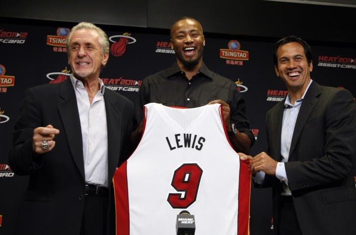 Miami Heat president Pat Riley, left, forward Rashard Lewis, center, and head coach Erik Spoelstra, right, hold up Lewis' jersey after he signed an NBA basketball contract with the Heat, Wednesday, July 11, 2012, in Miami. (AP Photo/Lynne Sladky)
